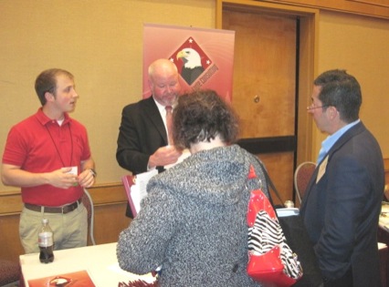 Attendees visiting the Eagle consulting booth